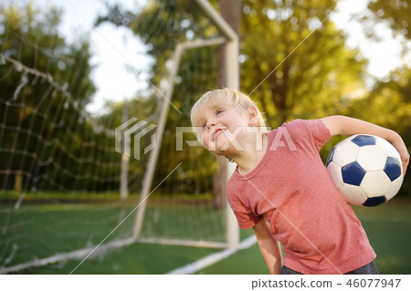 Little boy having fun playing a soccer/football Little boy having fun playing a soccer/football 46077947