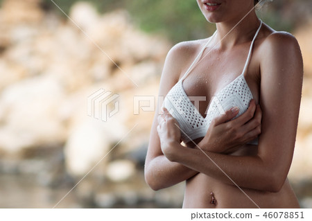 Woman in swimwear standing near sea Woman in swimwear standing near sea 46078851