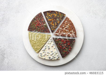 Round chocolate pizza pieces on white textured background 46083115