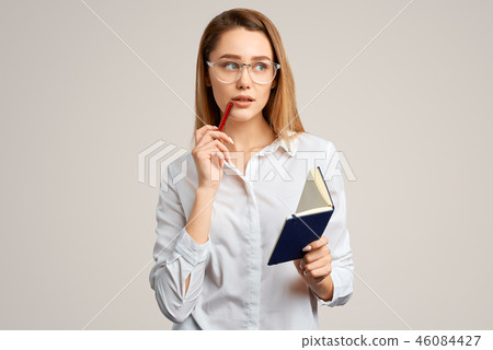 Thoughtful beautiful blonde girl in a white blouse Thoughtful beautiful blonde girl in a white blouse 46084427