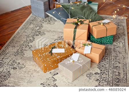 Christmas composition. Christmas gifts, fir tree branches, knitted blanket on white wooden 46085024