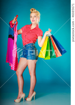 Pinup girl with shopping bags buying clothes dress 46085671