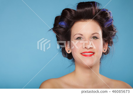 girl with curlers in hair, woman preparing to party. 46085673