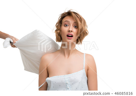 Girl hitted on her back with a pillow isolated shot 46085816