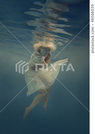Woman in a white dress under water Woman in a white dress under water 46086039