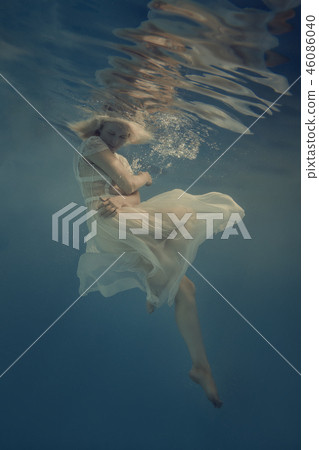 Woman in a white dress under water Woman in a white dress under water 46086040