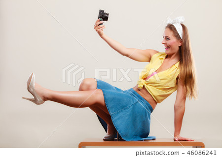 Pin up girl woman taking photo with camera. Pin up girl woman taking photo with camera. 46086241