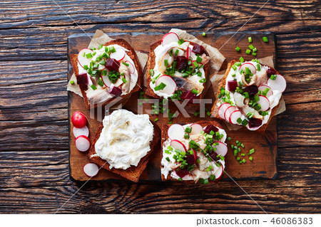 Smorrebrod with fish on a board 46086383