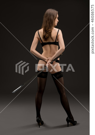 Young woman in underwear and stockings rearview Young woman in underwear and stockings rearview 46086575