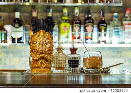 a glass tiki on the bar a glass tiki on the bar 46088324
