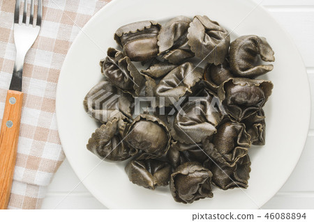 Squid ink tortellini pasta. Squid ink tortellini pasta. 46088894