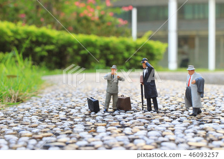 a small figures business men stand on a small figures business men stand on 46093257