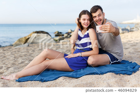 Happy loving couple resting and taking selfie 46094829
