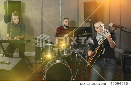 excited girl rock singer with guitar during rehearsal excited girl rock singer with guitar during rehearsal 46094986
