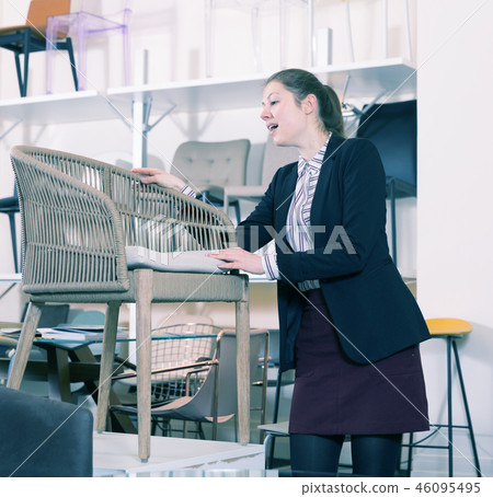 Girl searching new chair in store 46095495