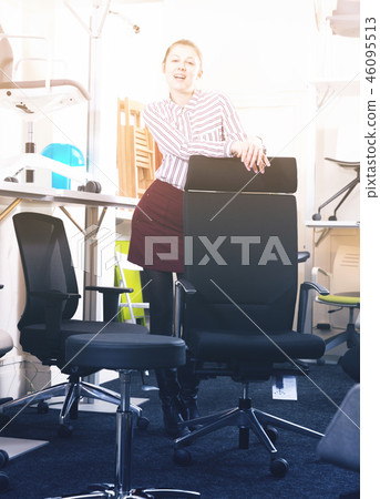 Smiling girl standing in chair shop 46095513