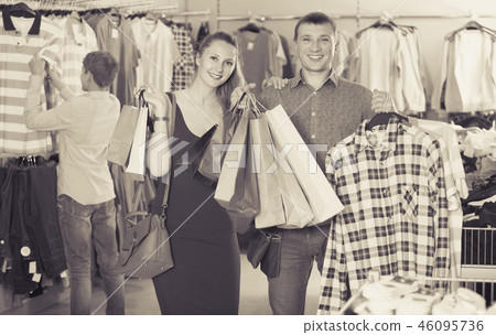 wife and husband with purchases in bags at apparel store 46095736