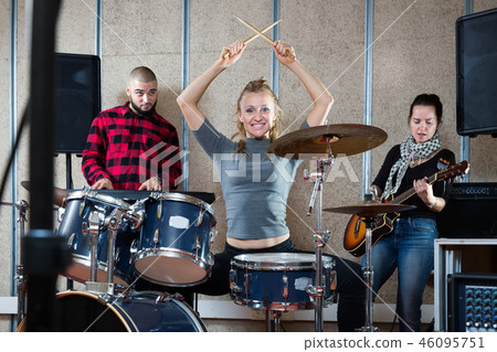 Music band with glad girl drummer rehearsing Music band with glad girl drummer rehearsing 46095751