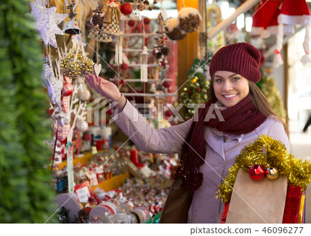 Girl choosing Christmas decoration 46096277