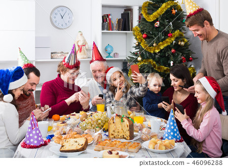 Large family making numerous photos during Christmas dinner 46096288