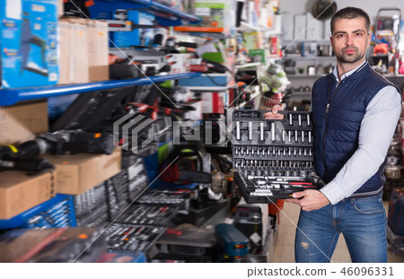 Adult man is buying new box for tools 46096331