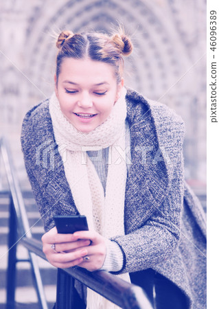 female in the historical center with mobile female in the historical center with mobile 46096389