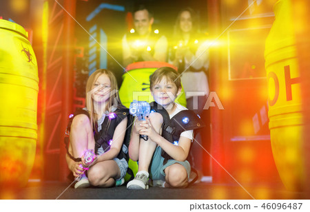 Kids sitting in beams with laser guns 46096487