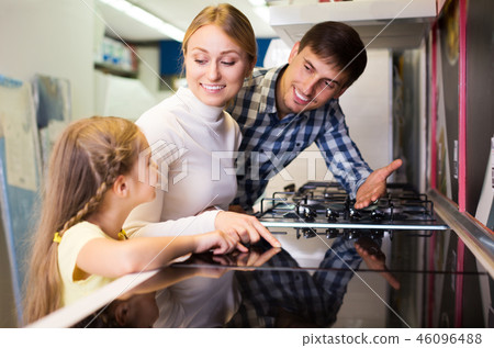 Family buying modern cookstove 46096488