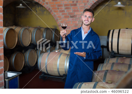 Male winemaker having glass of wine in hands 46096522
