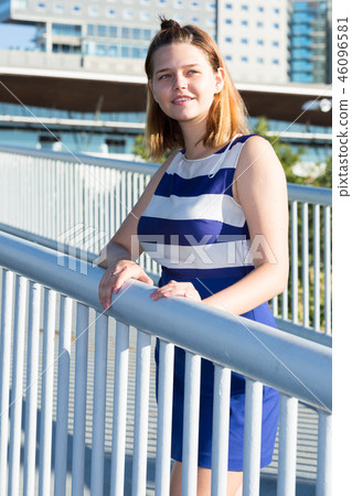 Smiling girl standing on bridge Smiling girl standing on bridge 46096581