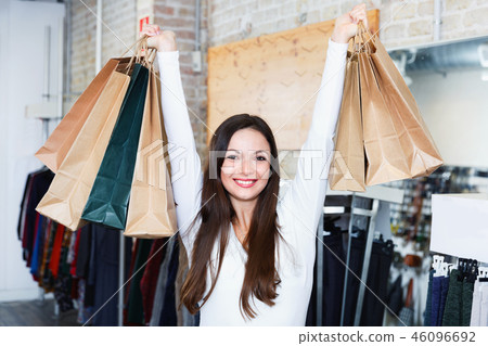 Young woman with bags happinnes from purchases in the clothes shop 46096692