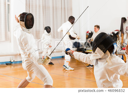 Active group practicing fencing techniques 46096832