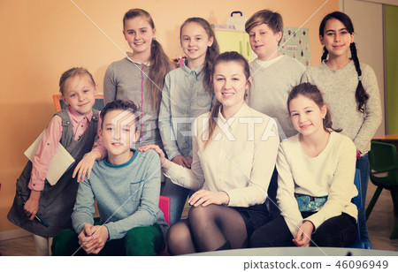 Female teacher with schoolchildren in classroom Female teacher with schoolchildren in classroom 46096949