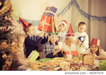 Smiling exchanging Christmas gifts 46097078