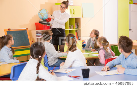 Positive boys and girls listening teacher Positive boys and girls listening teacher 46097093