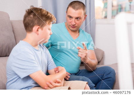 Sad guy with his father are resting and talking about teenage life 46097176