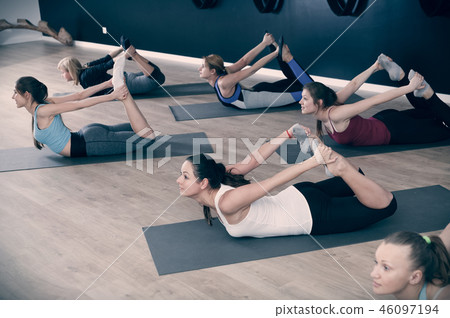 Females exercising during yoga class 46097194