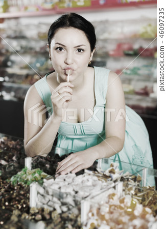 Woman posing to photographer with lollypop 46097235