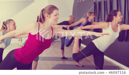 Females practicing yoga in studio 46097316