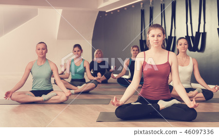Girls in lotus positions in yoga studio 46097336