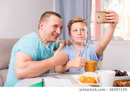 Man with his son are taking selfie together Man with his son are taking selfie together 46097339