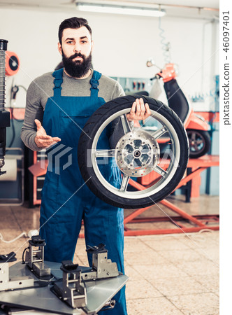 Work motorcycle repair shows the repaired tire Work motorcycle repair shows the repaired tire 46097401