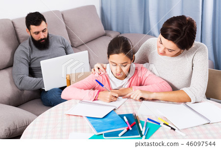 Mother helping daughter with homework 46097544
