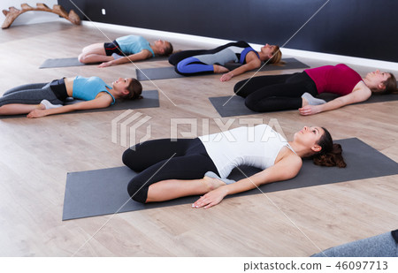 Females exercising during yoga class Females exercising during yoga class 46097713