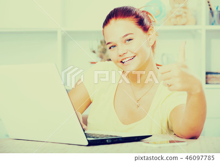 girl student holding thumbs up indoors . girl student holding thumbs up indoors . 46097785