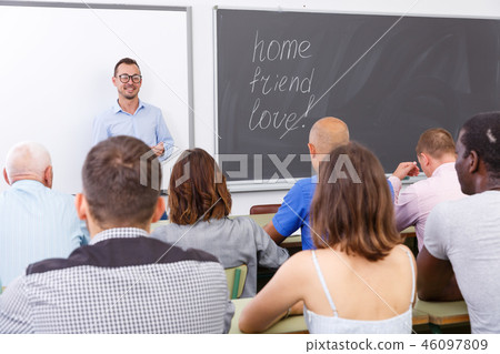 Young lecturer talking to mixed age students Young lecturer talking to mixed age students 46097809