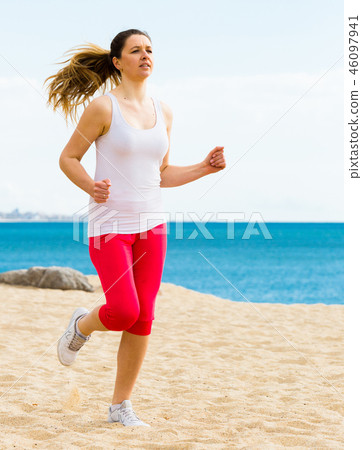 Woman running on beach Woman running on beach 46097941
