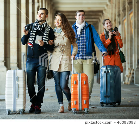 travelers with baggage sightseeing and smiling in autumn 46098098
