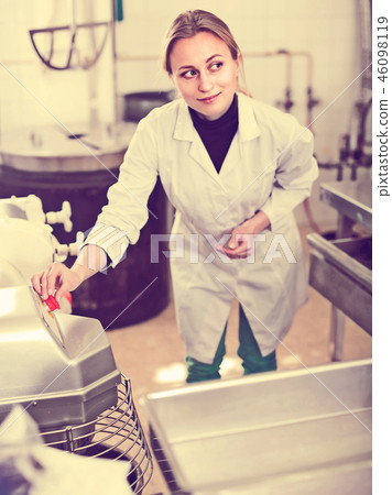 Portrait of young woman working in modern food factory Portrait of young woman working in modern food factory 46098119