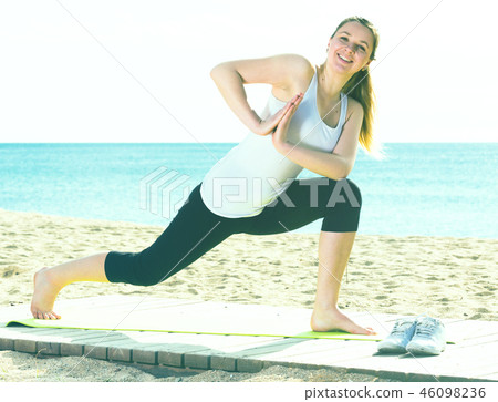 Woman doing yoga standing Woman doing yoga standing 46098236